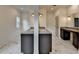 Bright bathroom featuring double vanities, stone countertops, marble floors, and modern fixtures and lighting at 11305 Knollwood Bend, Johns Creek, GA 30097