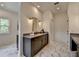A stylish bathroom vanity features double sinks and a modern countertop with gold fixtures and marble-look flooring at 11305 Knollwood Bend, Johns Creek, GA 30097