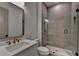 A modern bathroom boasts sleek fixtures and a frameless glass shower at 11305 Knollwood Bend, Johns Creek, GA 30097