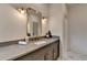 Modern bathroom featuring marble flooring, an elegant grey vanity with gold fixtures, and ample counter space at 11305 Knollwood Bend, Johns Creek, GA 30097