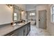 Modern bathroom featuring marble flooring, a large soaking tub, and an elegant grey vanity with gold fixtures at 11305 Knollwood Bend, Johns Creek, GA 30097