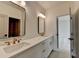 Modern bathroom features double sinks, white countertops, and access to a shower room at 11305 Knollwood Bend, Johns Creek, GA 30097