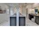 A dual vanity in the primary bathroom has marble floors, gray cabinets, and gold fixtures with ample space at 11305 Knollwood Bend, Johns Creek, GA 30097