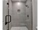 Modern bathroom featuring a frameless glass shower enclosure with gray tiled walls at 11305 Knollwood Bend, Johns Creek, GA 30097