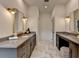 The primary bathroom features marble flooring, dual vanities, and modern fixtures to add a touch of luxury to your routine at 11305 Knollwood Bend, Johns Creek, GA 30097