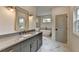 Bathroom with modern gray vanity and marble floors leading to soaking tub and glass shower at 11305 Knollwood Bend, Johns Creek, GA 30097