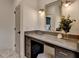 Bathroom vanity featuring gold mirror and lights, counter space, and gray cabinets, perfect for getting ready in the morning at 11305 Knollwood Bend, Johns Creek, GA 30097