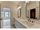 Modern bathroom featuring a double sink vanity with quartz countertop and brushed gold fixtures at 11305 Knollwood Bend, Johns Creek, GA 30097