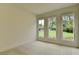 Bright bedroom features plush carpet and multiple windows with backyard views at 11305 Knollwood Bend, Johns Creek, GA 30097