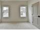 A bright bedroom with neutral carpeting and walls and a single door closet at 11305 Knollwood Bend, Johns Creek, GA 30097