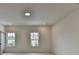 Bedroom view showcasing two windows and recessed lighting for added brightness at 11305 Knollwood Bend, Johns Creek, GA 30097