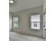 Bright bedroom with neutral carpeting and walls and views of neighboring homes at 11305 Knollwood Bend, Johns Creek, GA 30097