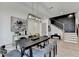 Modern dining room features a dark wood table and matching chairs under a unique pendant light fixture at 11305 Knollwood Bend, Johns Creek, GA 30097