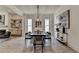 Elegant dining room featuring a dark wood table, modern lighting, and neutral decor at 11305 Knollwood Bend, Johns Creek, GA 30097