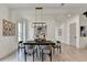 Bright dining room showcases a wooden table, modern light fixture, and hardwood floors at 11305 Knollwood Bend, Johns Creek, GA 30097