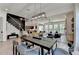 Open concept dining room with modern light fixture next to staircase leading into the living room at 11305 Knollwood Bend, Johns Creek, GA 30097