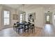 Dining room features a sleek black table and elegant gray chairs beneath modern lighting at 11305 Knollwood Bend, Johns Creek, GA 30097