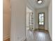 Bright entryway showcasing wood-look floors, a front door with glass accents, and decorative trim for a welcoming ambiance at 11305 Knollwood Bend, Johns Creek, GA 30097