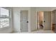 Hallway with two gray doors and view of houses outside the window at 11305 Knollwood Bend, Johns Creek, GA 30097