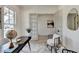 Bright home office showcasing open glass doors and a black desk with a decorative globe at 11305 Knollwood Bend, Johns Creek, GA 30097