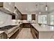 Spacious kitchen features stainless steel appliances, dark wood cabinetry, and ample counter space at 11305 Knollwood Bend, Johns Creek, GA 30097