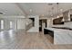 Modern kitchen open to living area with island, pendant lights, and stainless appliances at 11305 Knollwood Bend, Johns Creek, GA 30097