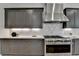 Stylish kitchen features a gas range, dark cabinets, and stainless steel appliances at 11305 Knollwood Bend, Johns Creek, GA 30097