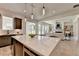 Open concept with kitchen island, pendant lights, and open view of living room with fireplace at 11305 Knollwood Bend, Johns Creek, GA 30097