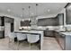 Well-designed kitchen with seating, island, gray cabinets, stainless steel appliances, and modern lighting at 11305 Knollwood Bend, Johns Creek, GA 30097