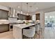 Modern kitchen featuring a marble waterfall island, stainless steel appliances, and stylish pendant lighting at 11305 Knollwood Bend, Johns Creek, GA 30097