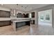 Contemporary kitchen featuring stainless steel appliances, waterfall island, and modern pendant lighting at 11305 Knollwood Bend, Johns Creek, GA 30097