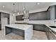 Stunning kitchen features gray cabinetry, stainless steel appliances, marble countertops and a large kitchen island at 11305 Knollwood Bend, Johns Creek, GA 30097