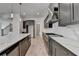 Bright open kitchen with stainless steel appliances, a large island with quartz countertops and gray modern cabinetry at 11305 Knollwood Bend, Johns Creek, GA 30097