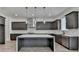 Modern kitchen features gray cabinetry, stainless steel appliances, marble countertops and a large kitchen island at 11305 Knollwood Bend, Johns Creek, GA 30097