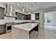 Stylish kitchen with gray cabinets, stainless steel appliances, island with white countertop and pendant lighting at 11305 Knollwood Bend, Johns Creek, GA 30097