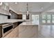 Open-concept kitchen boasts dark cabinets, stainless steel appliances, and a large center island, perfect for entertaining at 11305 Knollwood Bend, Johns Creek, GA 30097