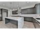 Modern kitchen features gray cabinetry, stainless steel appliances, marble countertops and a large kitchen island at 11305 Knollwood Bend, Johns Creek, GA 30097