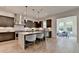 Bright kitchen with dark cabinets, stainless steel appliances, and a view to the sunroom at 11305 Knollwood Bend, Johns Creek, GA 30097
