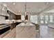 Contemporary kitchen features an island with seating and access to the living room at 11305 Knollwood Bend, Johns Creek, GA 30097