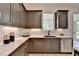 Modern kitchen with gray cabinets, white countertops, stainless steel appliances, and gold hardware at 11305 Knollwood Bend, Johns Creek, GA 30097