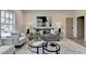 Cozy living room featuring neutral decor, plush seating, and large windows providing natural light at 11305 Knollwood Bend, Johns Creek, GA 30097