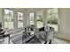 Sunroom featuring large windows, hardwood floors, and comfortable seating at 11305 Knollwood Bend, Johns Creek, GA 30097