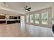 Bright living room with an open floor plan to the kitchen featuring modern appliances and ample windows at 11305 Knollwood Bend, Johns Creek, GA 30097