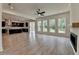 Bright living room with a ceiling fan, many windows, and an open floor plan to the kitchen at 11305 Knollwood Bend, Johns Creek, GA 30097