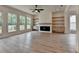Bright living room with large windows, fireplace, built-in shelves, and light hardwood floors at 11305 Knollwood Bend, Johns Creek, GA 30097