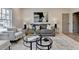 Cozy living room with soft gray sofa, glass tables, decorative pillows, and an abstract painting above the couch at 11305 Knollwood Bend, Johns Creek, GA 30097