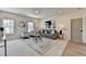 Comfortable living room featuring neutral decor, plush seating, and large windows providing natural light at 11305 Knollwood Bend, Johns Creek, GA 30097