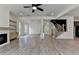 Open-concept living room featuring stairs, fireplace, and an open floor plan at 11305 Knollwood Bend, Johns Creek, GA 30097