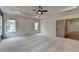 Bright main bedroom featuring neutral carpet, ceiling fan, and plenty of open space at 11305 Knollwood Bend, Johns Creek, GA 30097