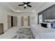 Spacious main bedroom featuring tray ceiling, gray paneled accent wall, and access to walk-in closet at 11305 Knollwood Bend, Johns Creek, GA 30097